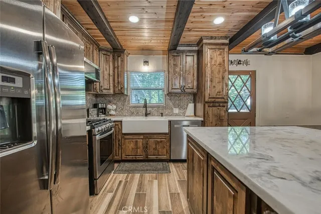 a kitchen with stainless steel appliances granite countertop a stove and a refrigerator