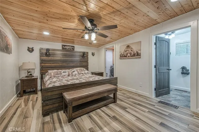 a bathroom with a granite countertop sink vanity mirror and toilet