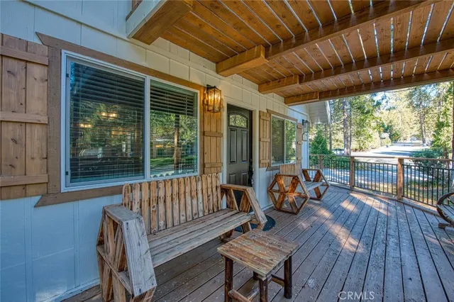 a living room with furniture a flat screen tv and a table