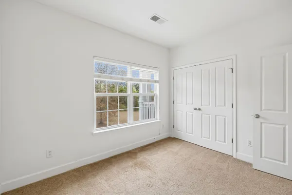 a view of bedroom with a bed and wooden floor