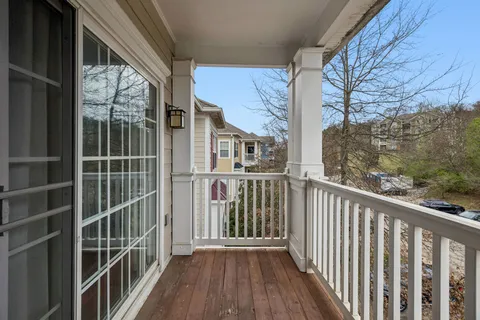 a view of a balcony with wooden floor