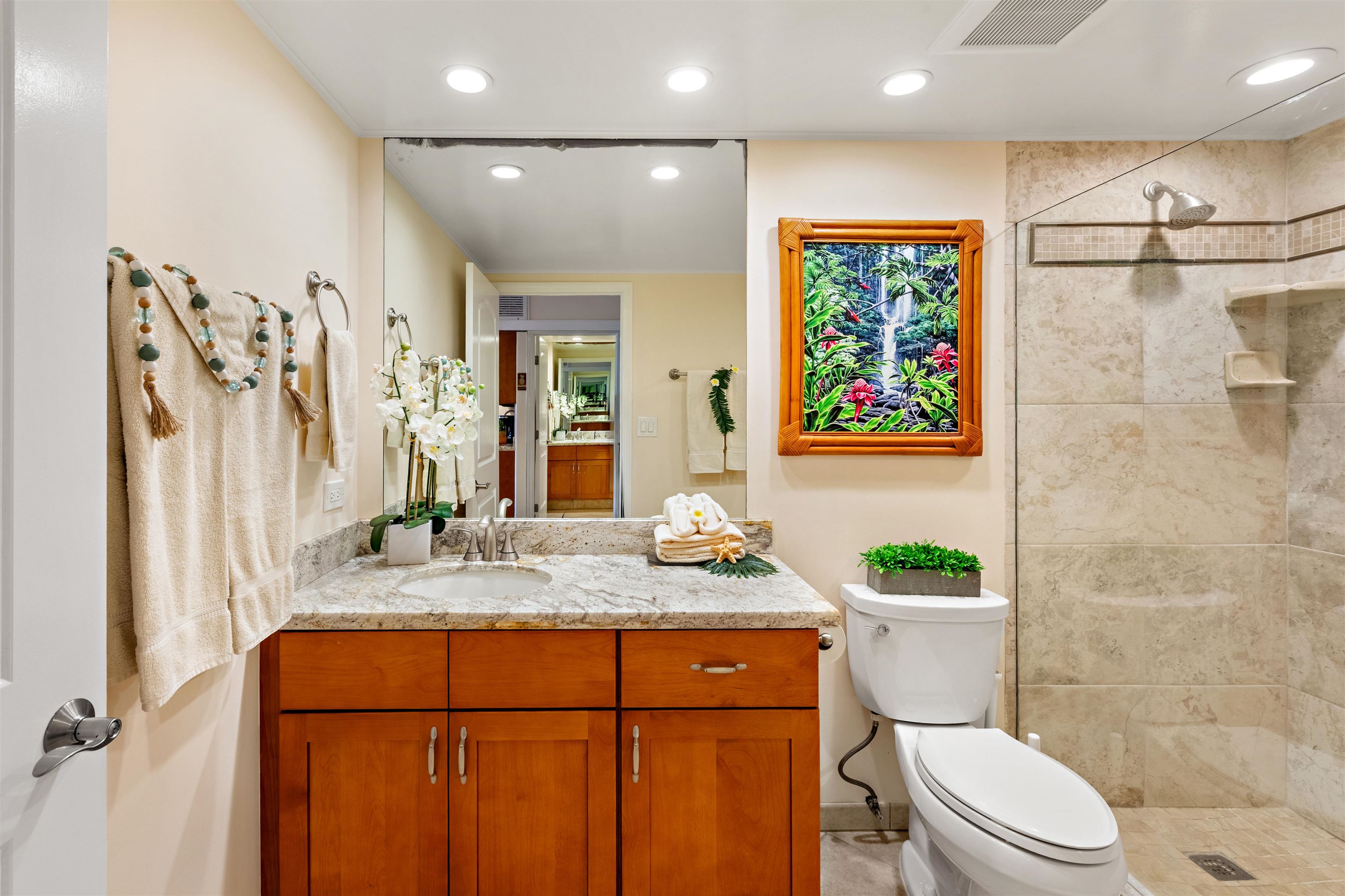 475 Front Street, Unit 430 Lahaina, HI 96761 - Photo 17 of 19 a bathroom with a granite countertop sink toilet and shower
