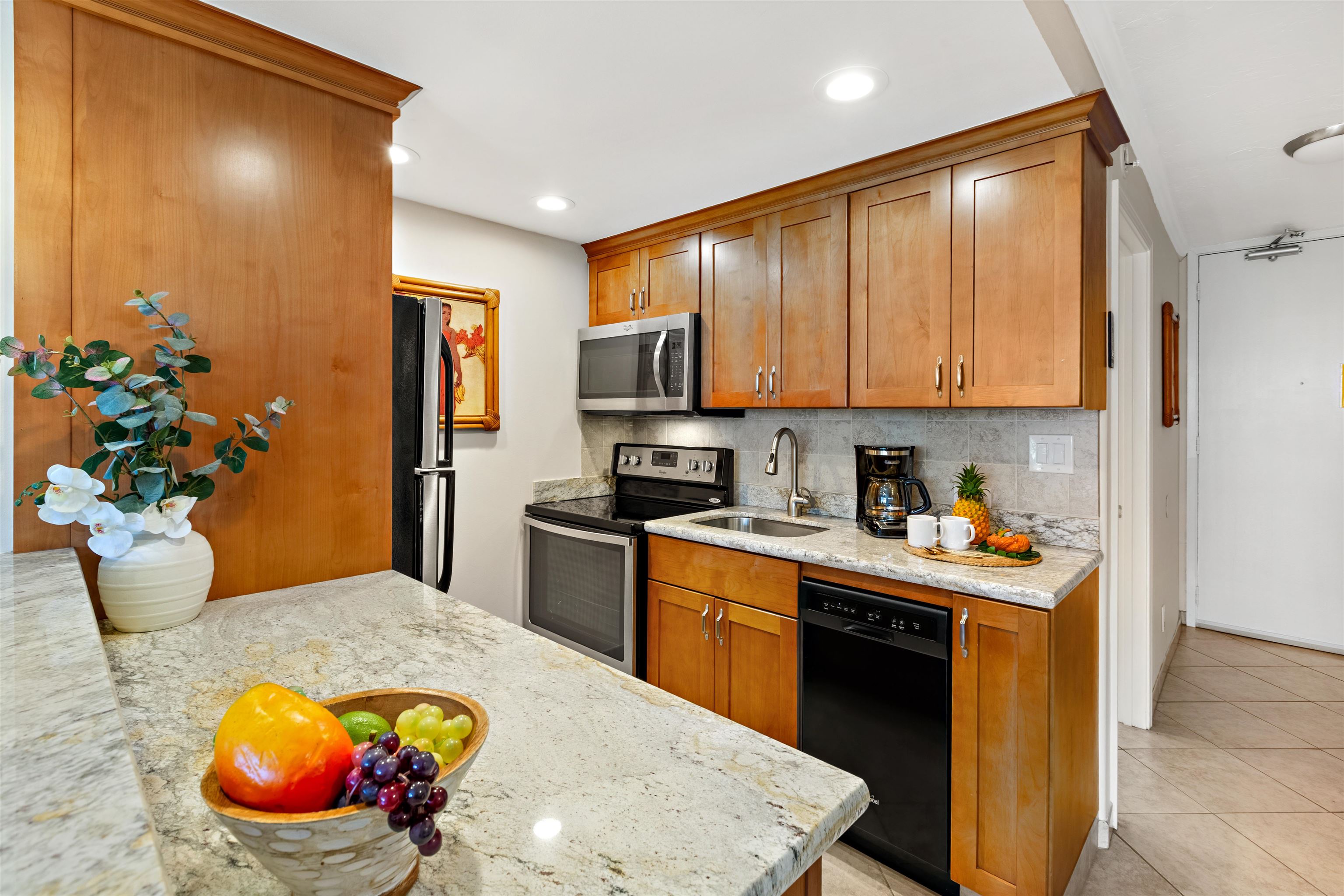 475 Front Street, Unit 430 Lahaina, HI 96761 - Photo 3 of 19 a kitchen with a sink a stove and cabinets