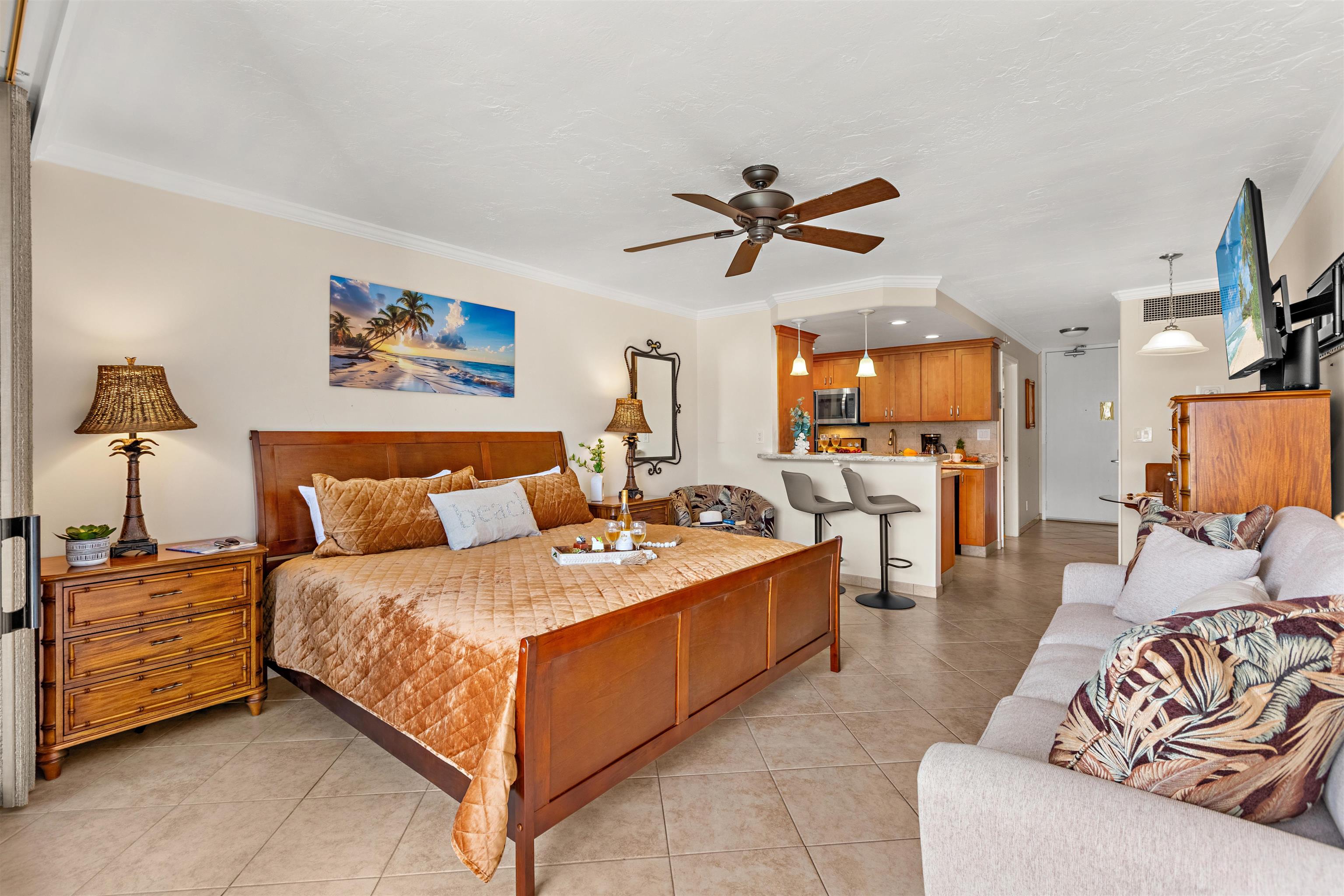 475 Front Street, Unit 430 Lahaina, HI 96761 - Photo 4 of 19 a spacious bedroom with a bed a couch and a flat screen tv