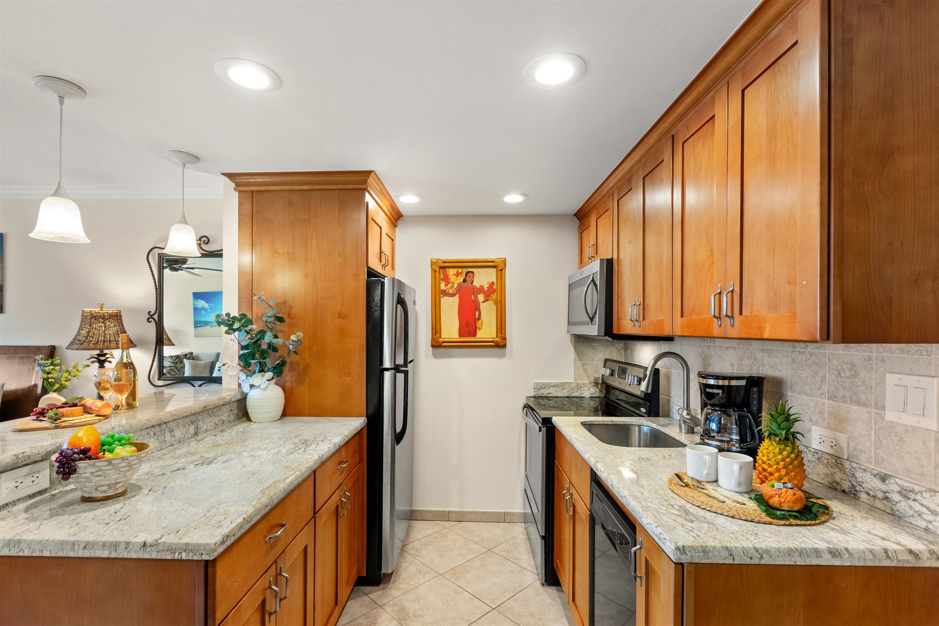 475 Front Street, Unit 430 Lahaina, HI 96761 - Photo 10 of 19 a kitchen with stainless steel appliances granite countertop a sink stove and refrigerator