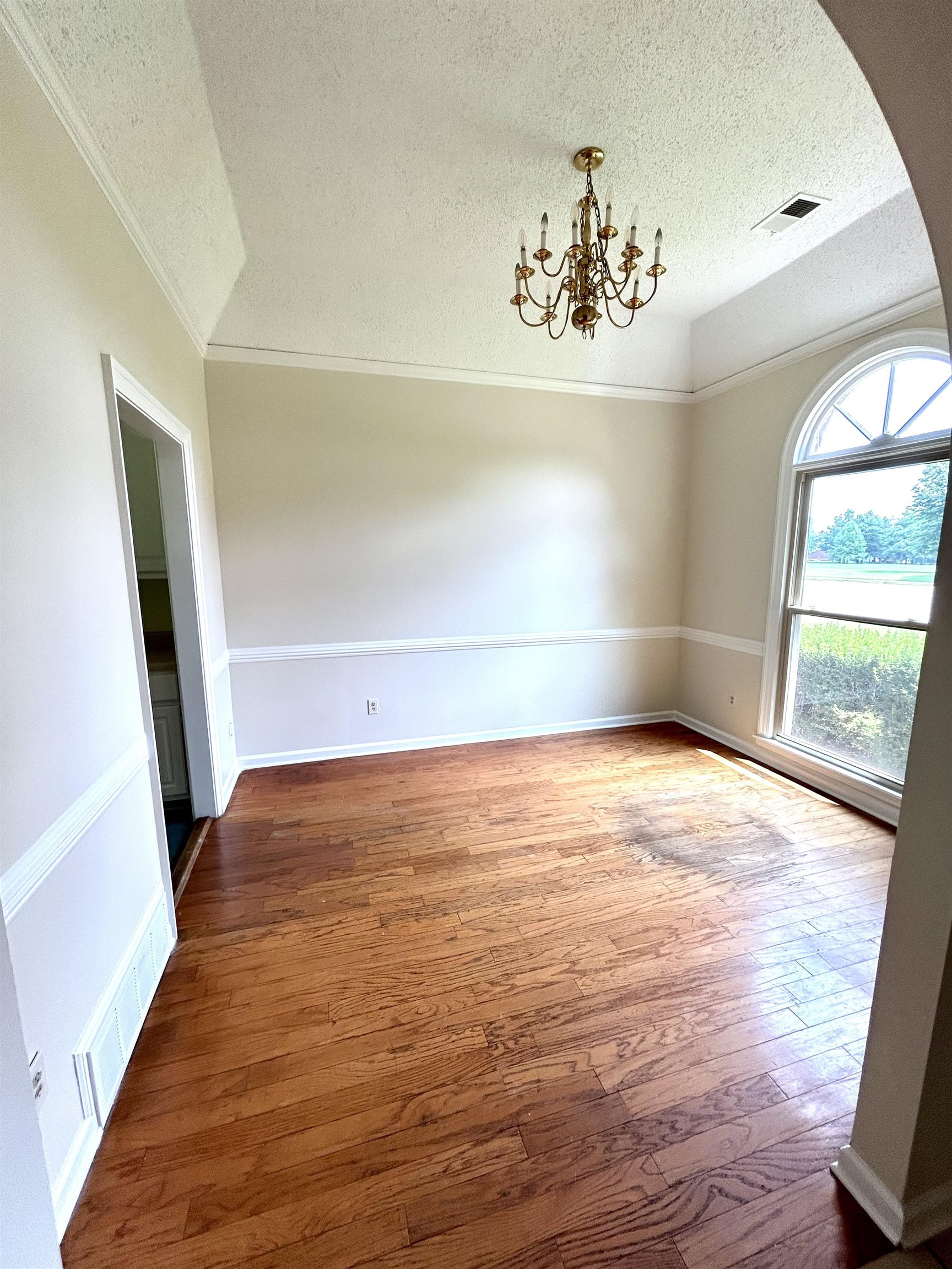 8528 Trinity Road Memphis, TN 38018 - Photo 4 of 21 wooden floor in an empty room with a window