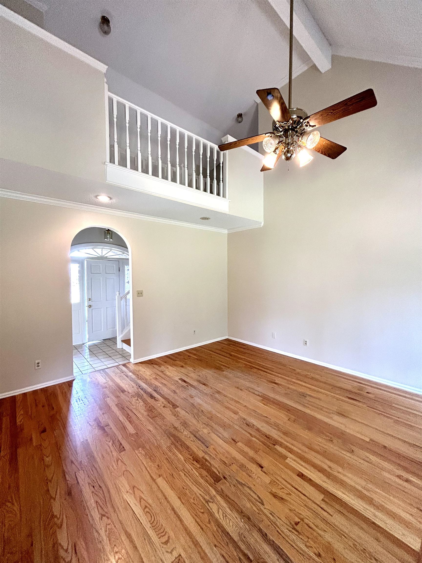8528 Trinity Road Memphis, TN 38018 - Photo 6 of 21 a view of an empty room with wooden floor and a chandelier fan