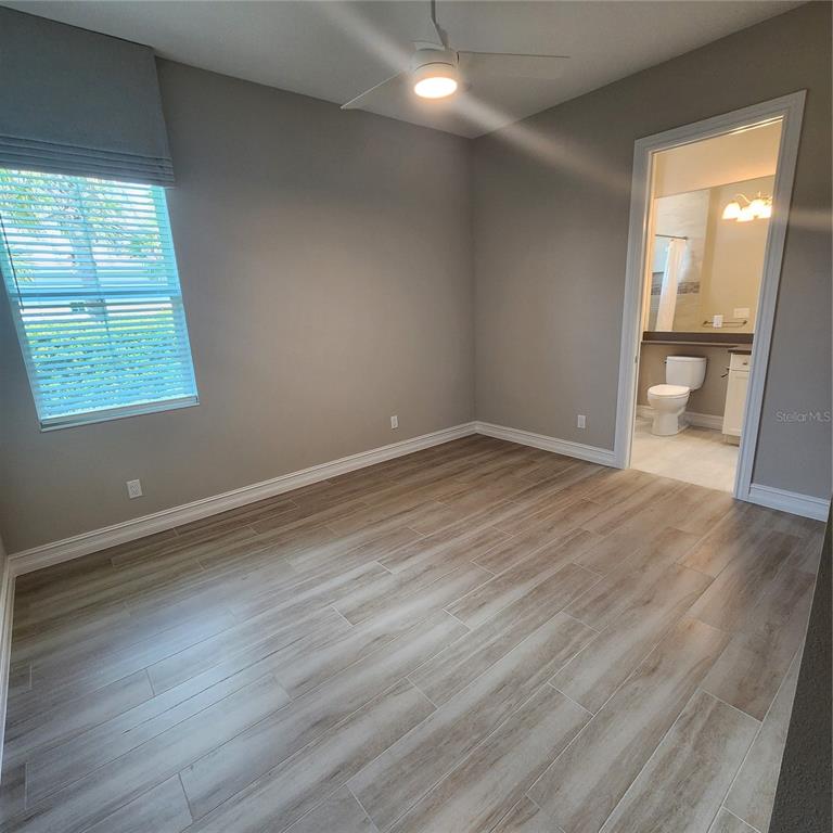 512 Blue Shell Loop Sarasota, FL 34240 - Photo 30 of 44 an empty room with wooden floor and windows