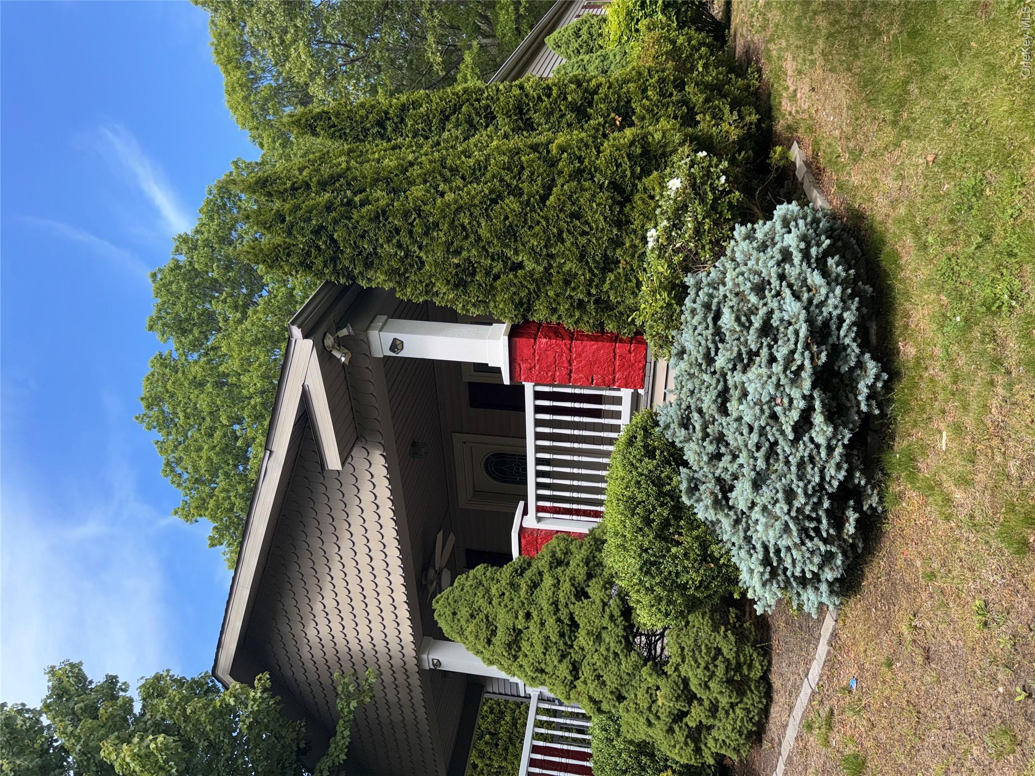 1661 Old Country Road, Unit 516 Riverhead, NY 11901 - Photo 50 of 50 a front view of a house with a yard