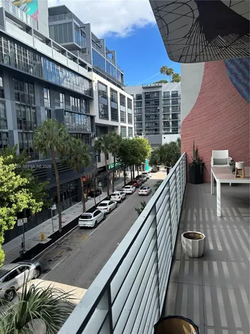 a view of balcony with seating space and potted plants