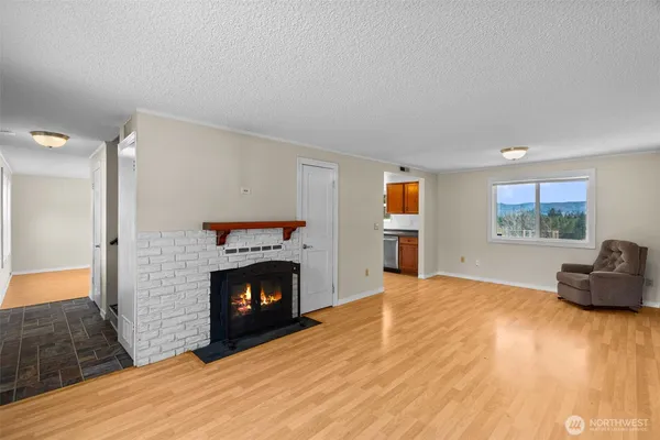 a view of a livingroom with a fireplace and a window