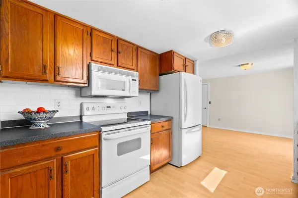 a kitchen with stainless steel appliances granite countertop wooden cabinets a sink and dishwasher