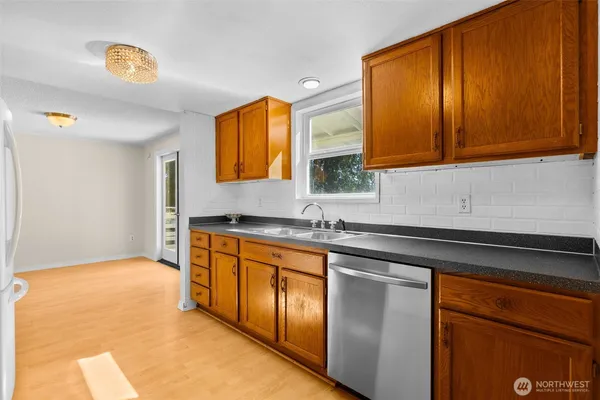 a view of empty room with wooden floor and cabinet