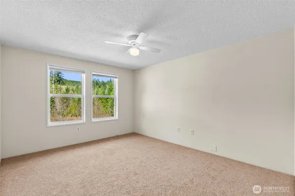 a view of an empty room with a ceiling fan