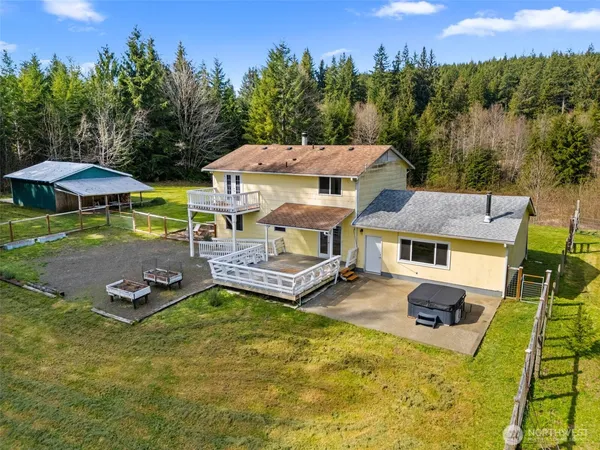 an aerial view of a house with swimming pool garden and patio
