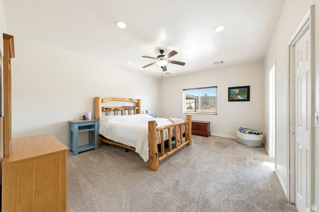 7776 Wagon Road East St. George, UT 84770 - Photo 22 of 76 Bedroom with light colored carpet, a ceiling fan, and recessed lighting