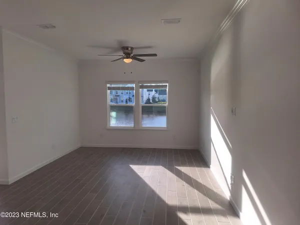 wooden floor in an empty room with a window