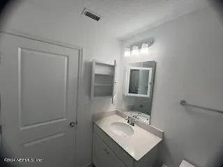 a bathroom with a sink toilet and mirror