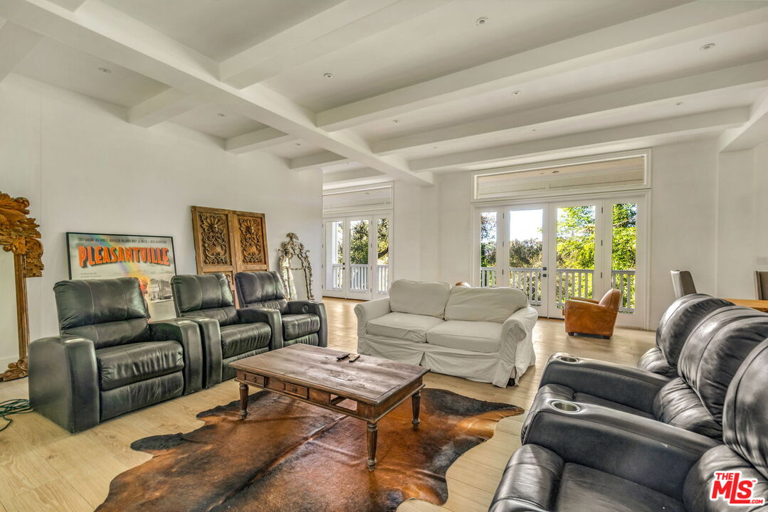 9669 Oak Pass Road Beverly Hills, CA 90210 - Photo 29 of 37 a living room with furniture or couch and a large window