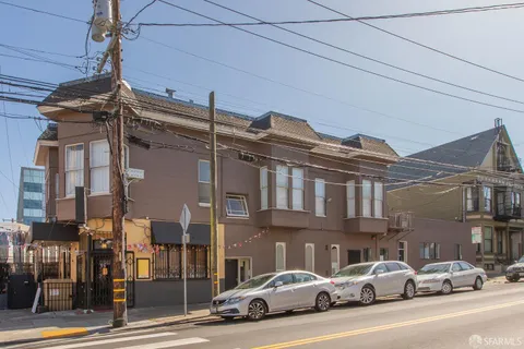 a couple of cars parked in front of a building