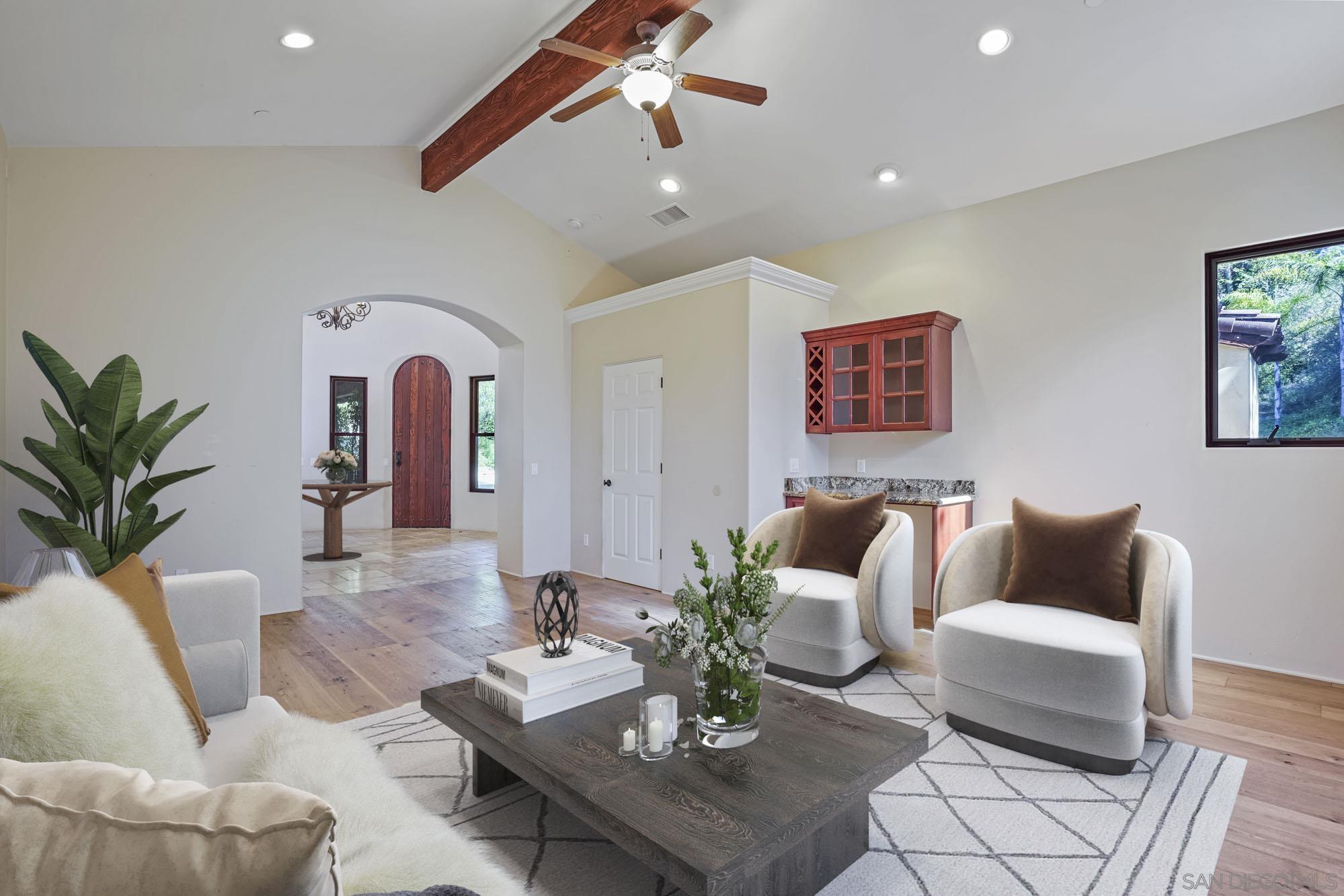 5352 Camino Jasmine Bonsall, CA 92003 - Photo 18 of 68 a living room with furniture potted plant and kitchen view
