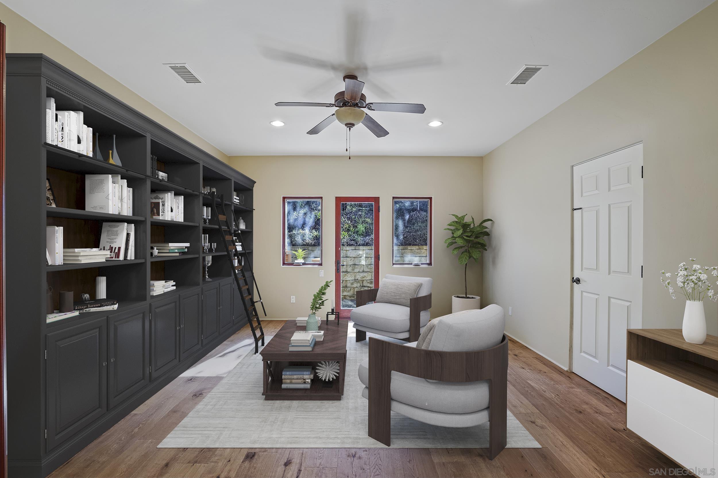 5352 Camino Jasmine Bonsall, CA 92003 - Photo 19 of 68 a living room with furniture and a book shelf