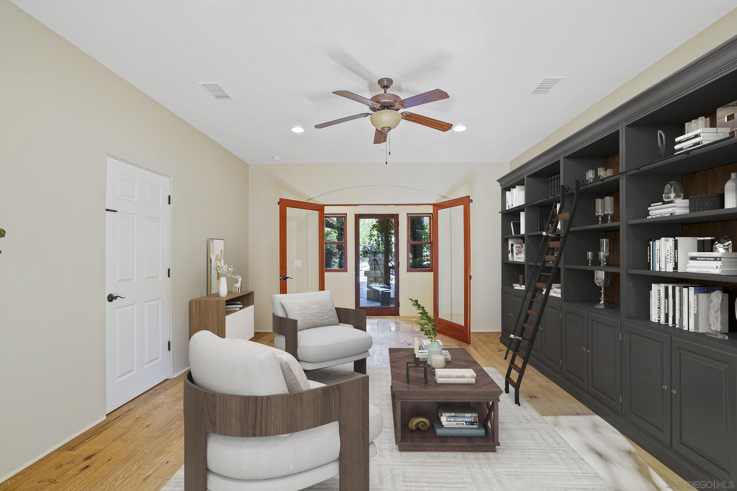 5352 Camino Jasmine Bonsall, CA 92003 - Photo 20 of 68 a living room with furniture a rug and a book shelf