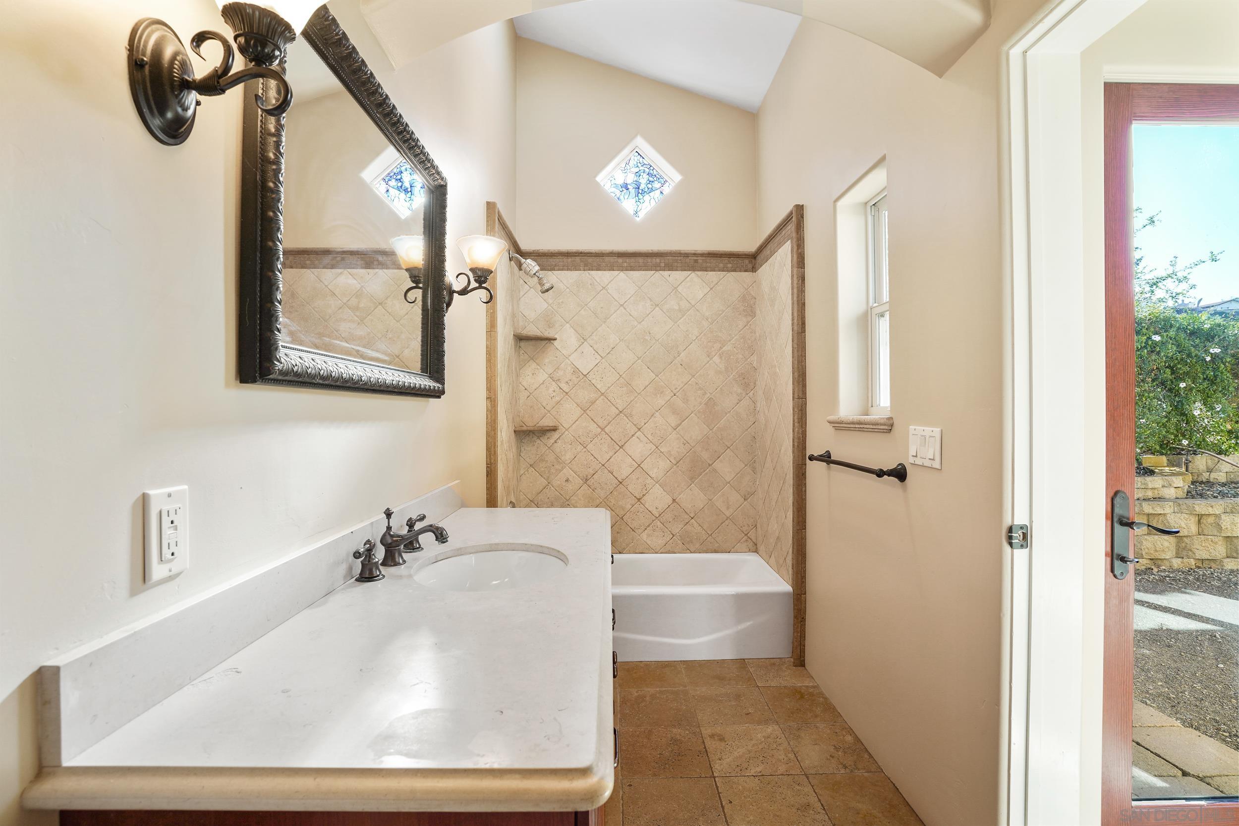 5352 Camino Jasmine Bonsall, CA 92003 - Photo 29 of 68 a bathroom with a sink a toilet and shower
