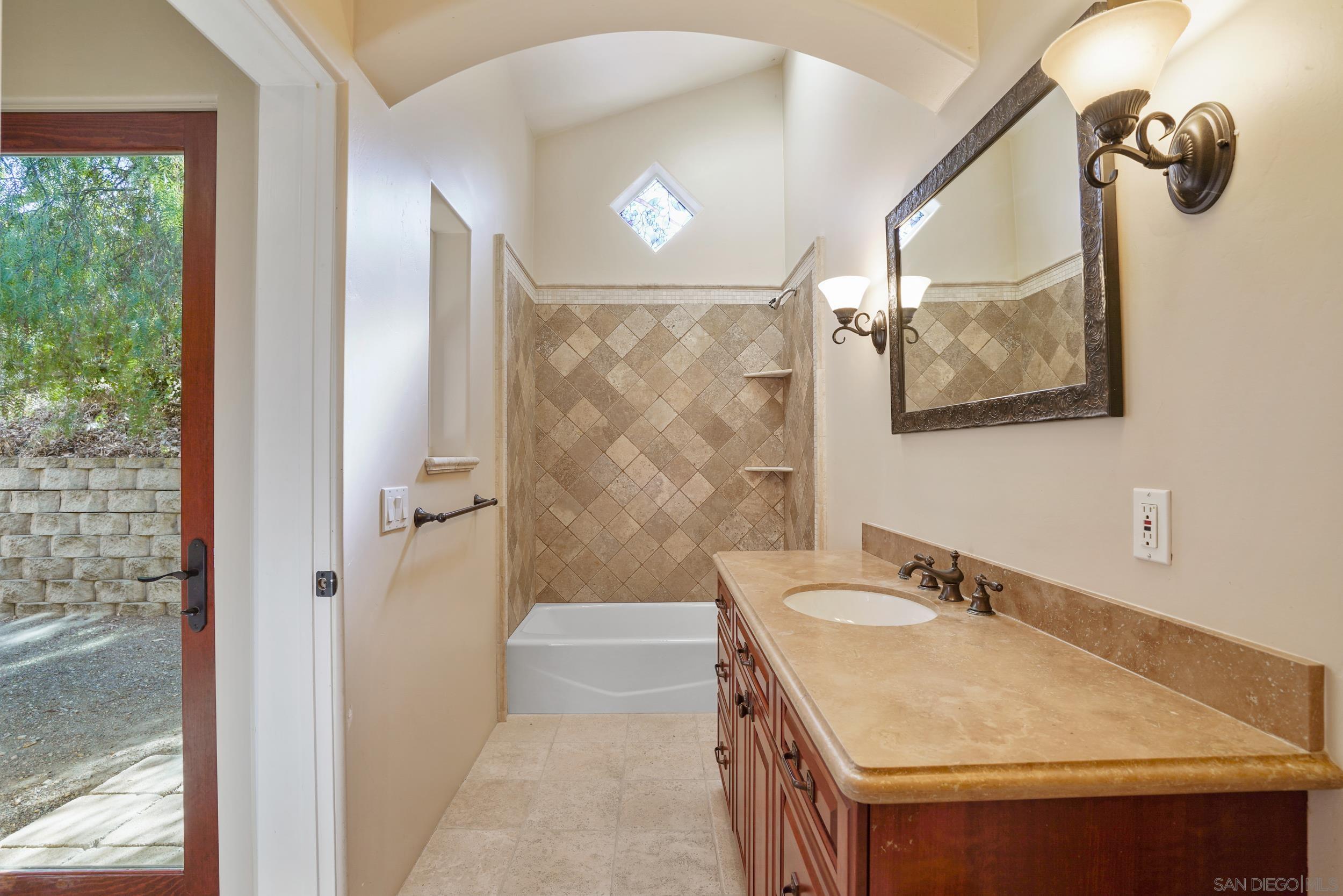5352 Camino Jasmine Bonsall, CA 92003 - Photo 32 of 68 a bathroom with a sink and a mirror