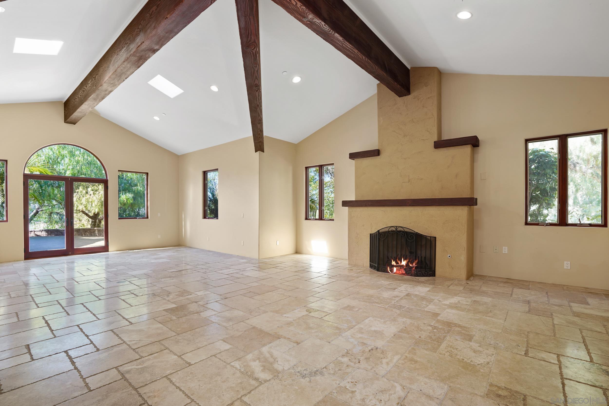 5352 Camino Jasmine Bonsall, CA 92003 - Photo 55 of 68 a view of an empty room with a fireplace and a window