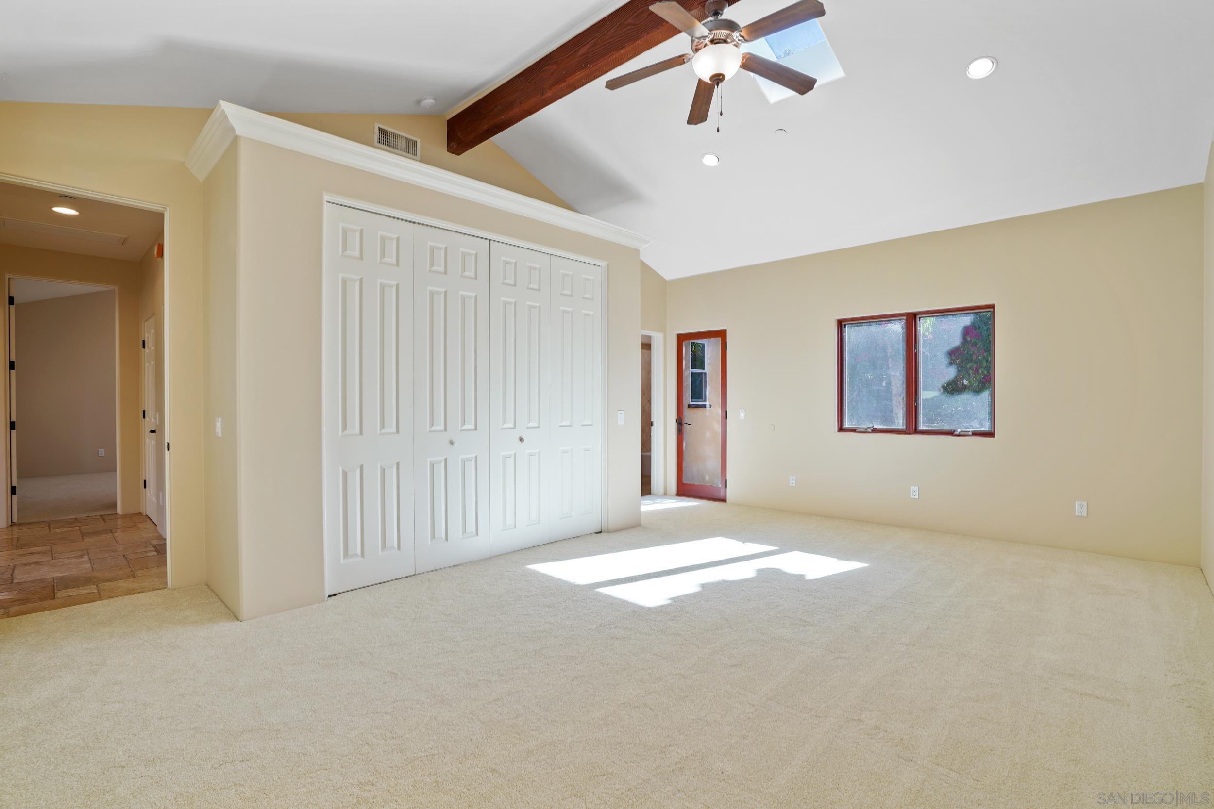 5352 Camino Jasmine Bonsall, CA 92003 - Photo 62 of 68 en empty room with windows and ceiling fan