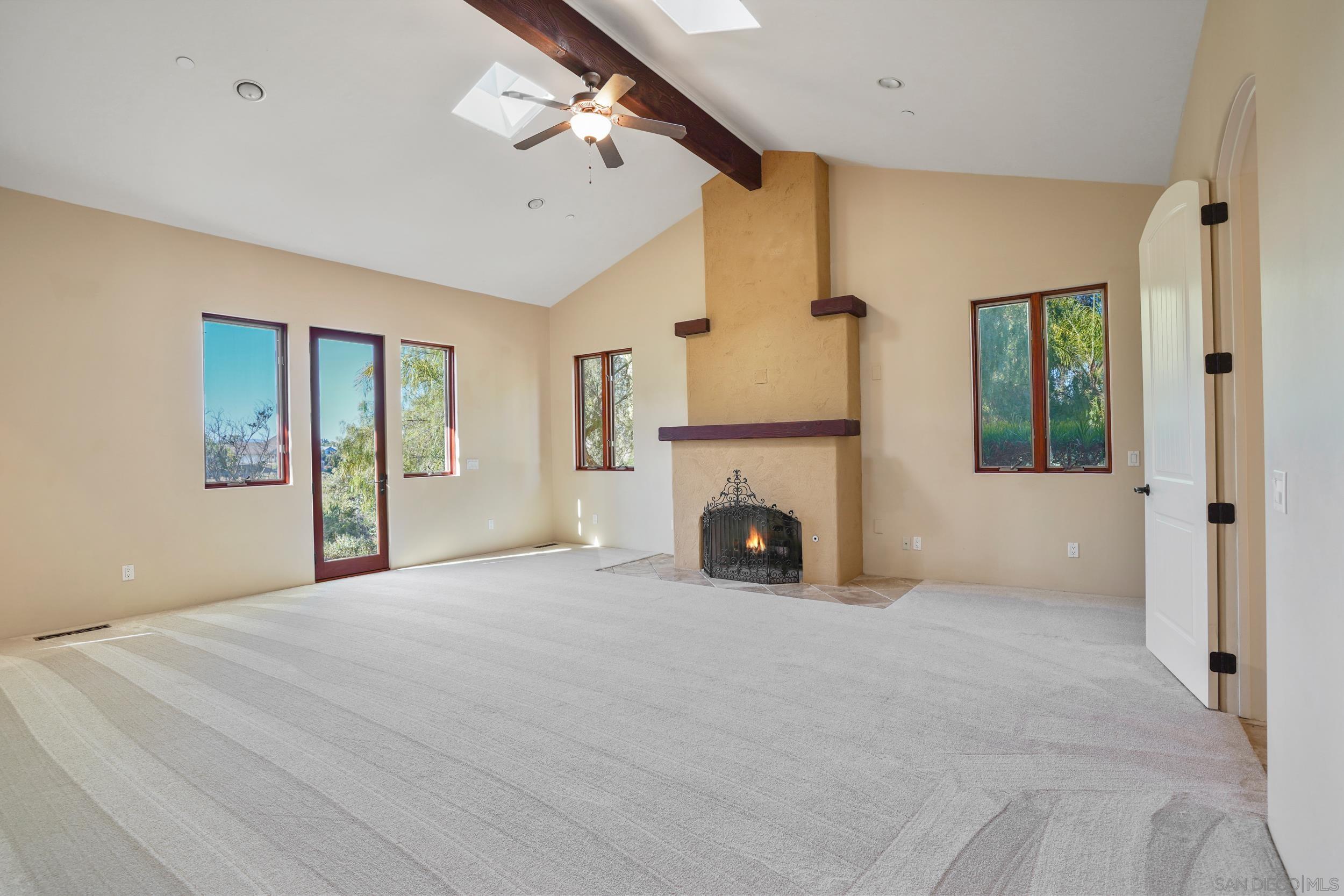 5352 Camino Jasmine Bonsall, CA 92003 - Photo 64 of 68 a view of an empty room with a fireplace and a window