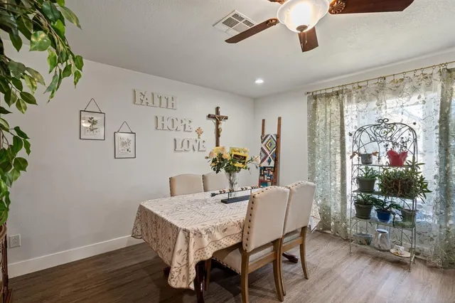 a dining room with furniture window and wooden floor