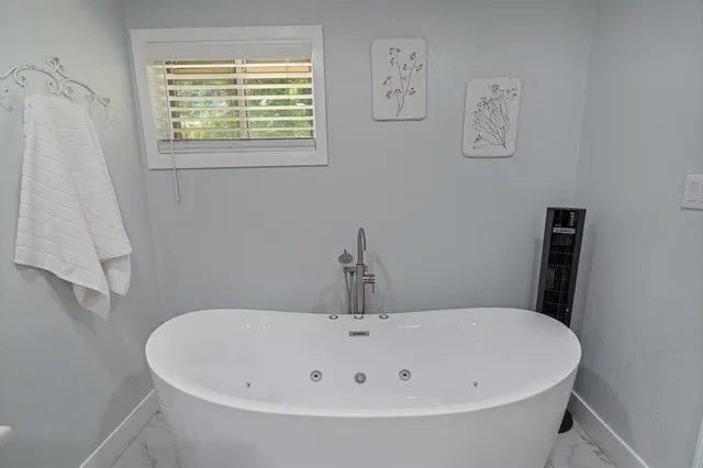 a white bath tub sitting in a bathroom