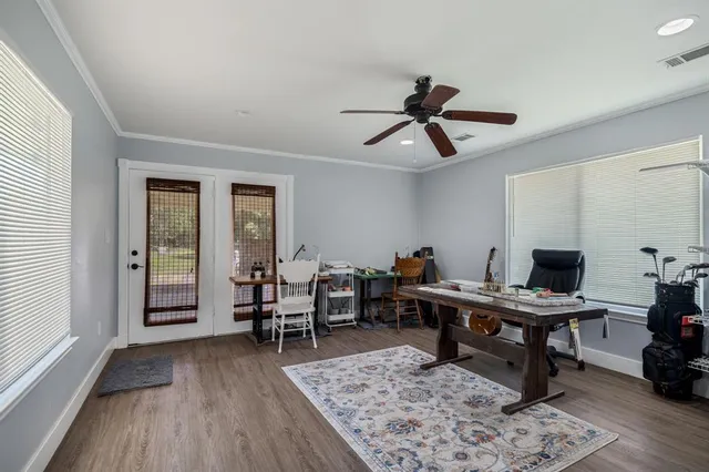 a view of a workspace with furniture window and wooden floor