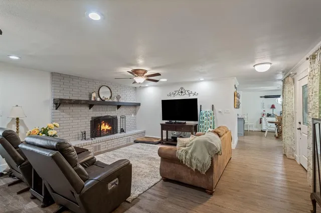 a living room with furniture a flat screen tv and a fireplace