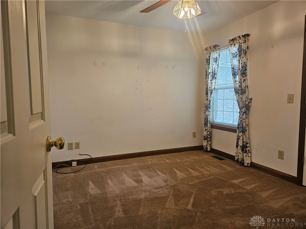 4909 Shannon Avenue Springfield, OH 45504 - Photo 10 of 21 This cozy room offers a tranquil escape, featuring carpeted flooring and natural light.