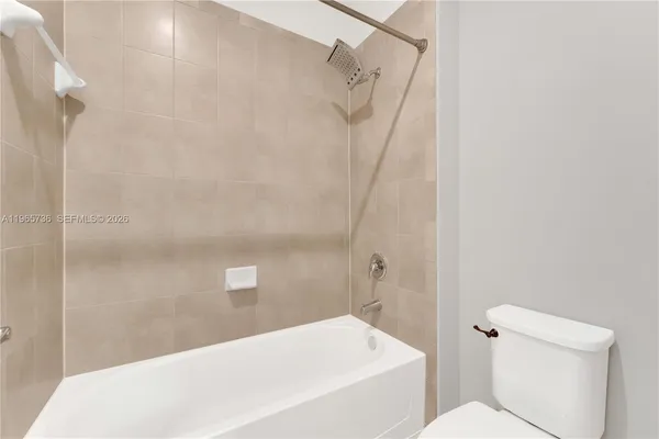 a bathroom with a white bath tub and a shower