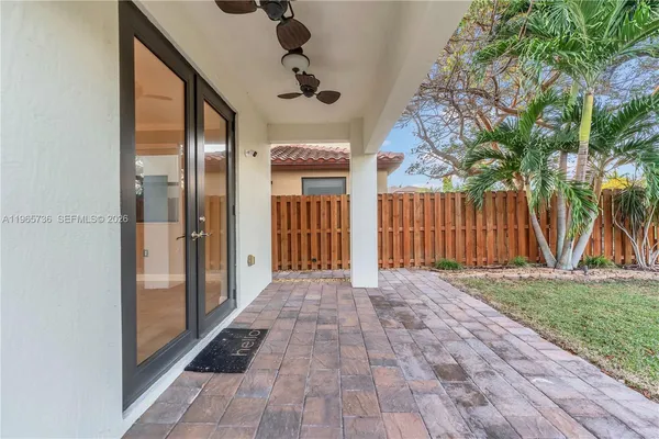 a view of a porch with wooden floor and fence