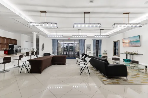 a living room with lots of furniture and kitchen view