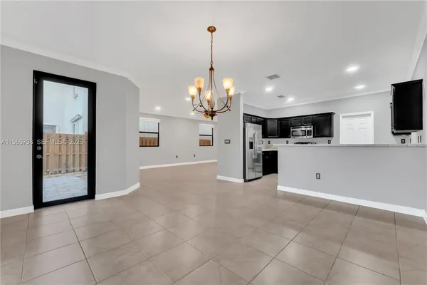a view of a kitchen with a microwave and a sink