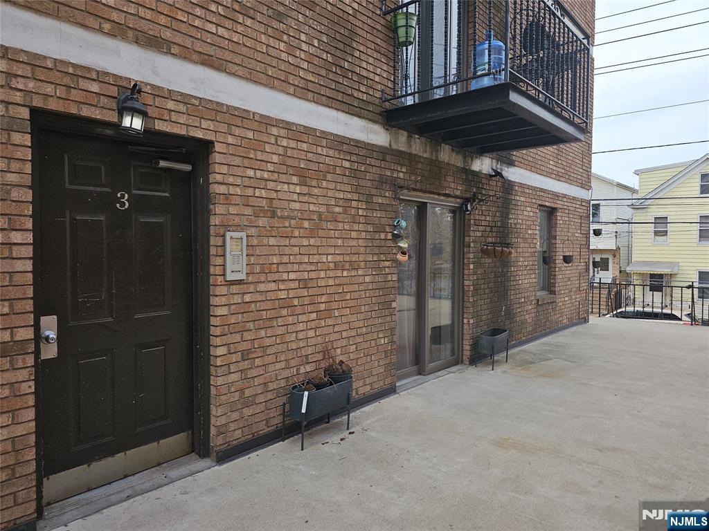 a view of a brick house with an outdoor space