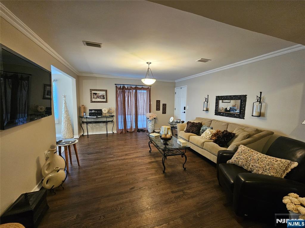 63-69 Rome Street Newark, NJ 07105 - Photo 11 of 14 a living room with furniture and a flat screen tv
