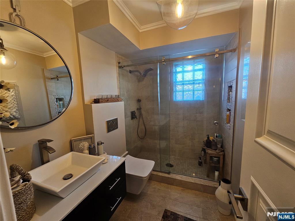 63-69 Rome Street Newark, NJ 07105 - Photo 13 of 14 a bathroom with a sink mirror toilet and shower