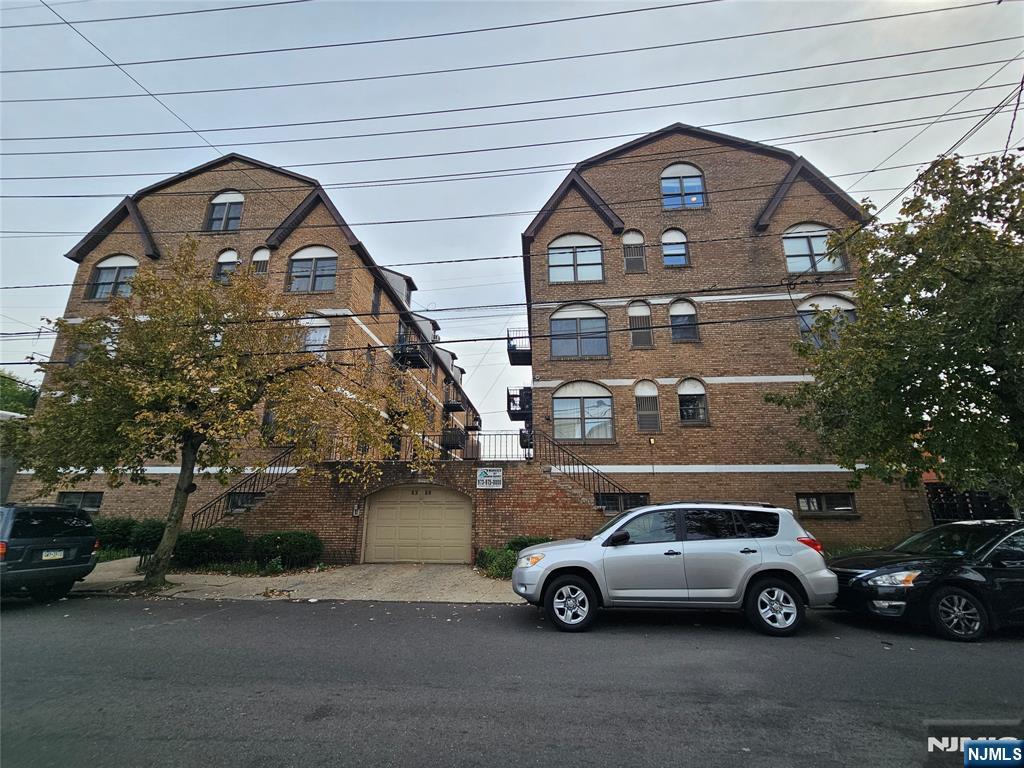 63-69 Rome Street Newark, NJ 07105 - Photo 3 of 14 a car parked in front of a house
