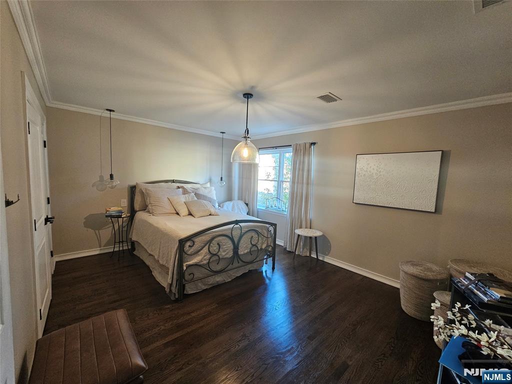 63-69 Rome Street Newark, NJ 07105 - Photo 4 of 14 a bedroom with a bed and wooden floor