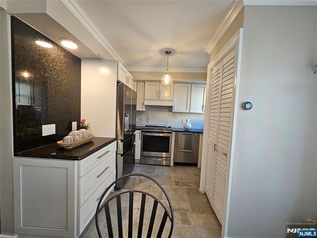 63-69 Rome Street Newark, NJ 07105 - Photo 7 of 14 a kitchen with stainless steel appliances kitchen island granite countertop a stove a sink and a refrigerator