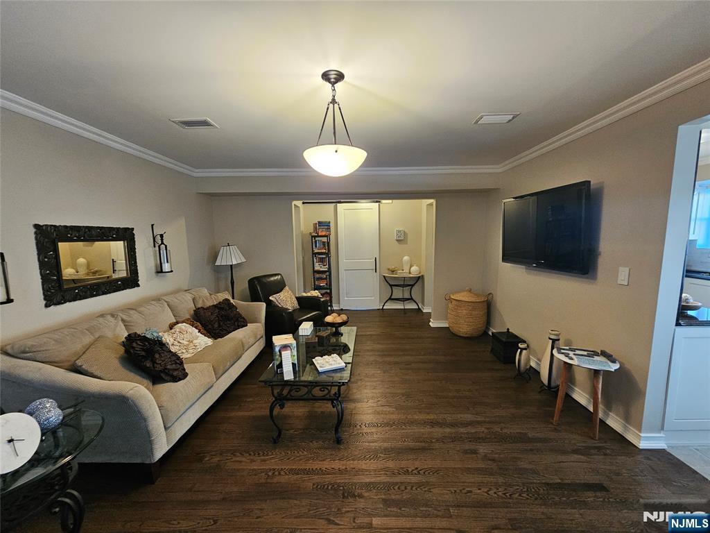 63-69 Rome Street Newark, NJ 07105 - Photo 9 of 14 a living room with furniture a flat screen tv and wooden floor