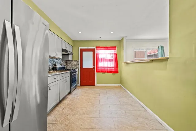 a kitchen with stainless steel appliances a refrigerator and a sink