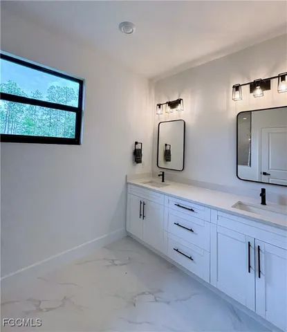 a bathroom with a double vanity sink and mirror